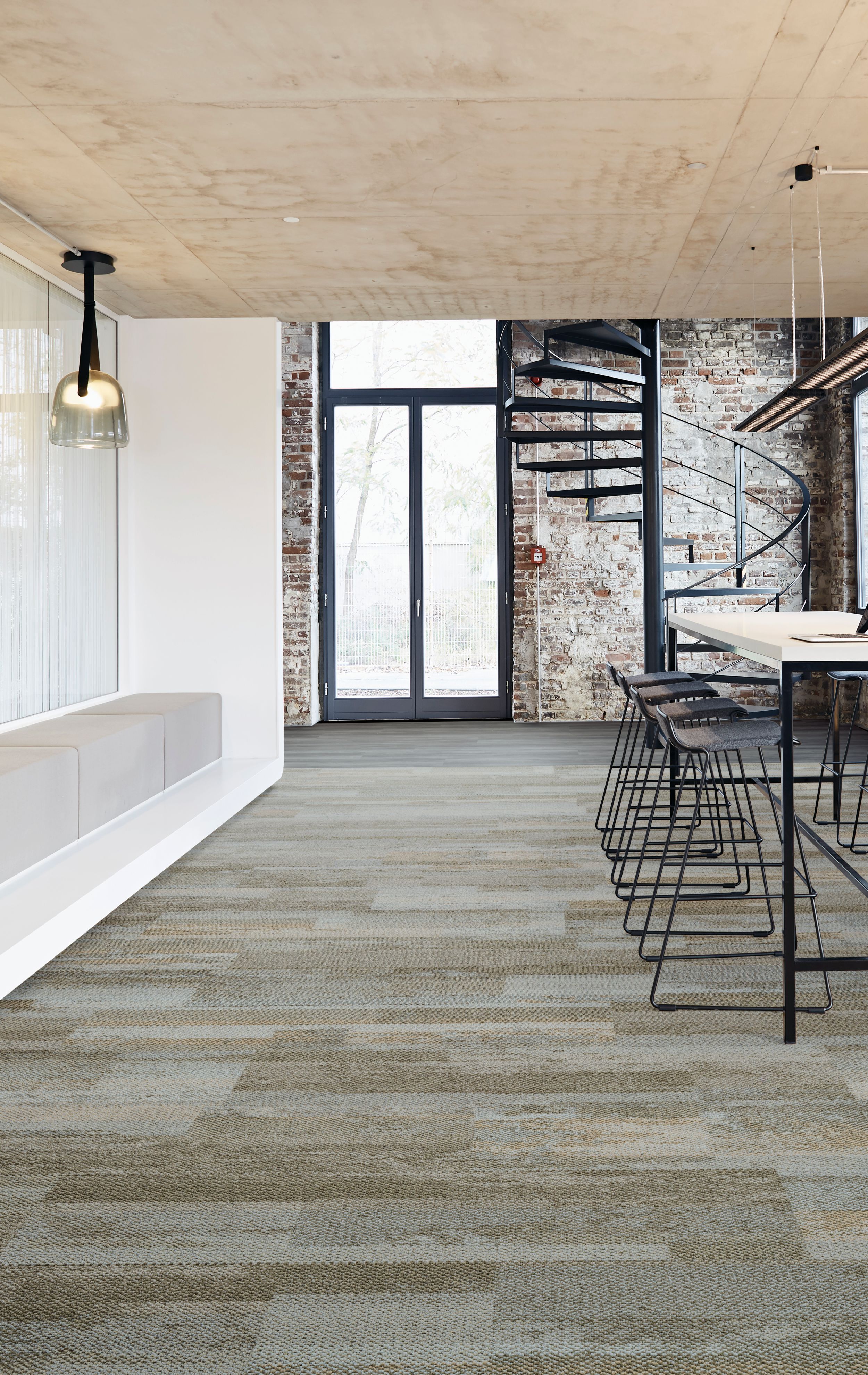 Interface Naturally Weathered plank carpet tile and Studio Set LVT in open office entryway with stairs and high top sitting area imagen número 7
